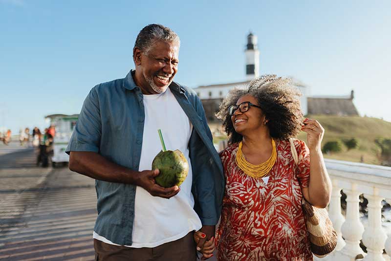 A retired couple spending time near the ocean.